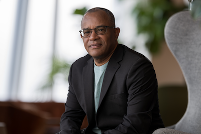 Headshot of author, wearing glasses, black blazer, facing camera